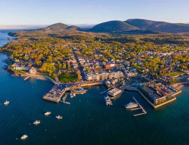 Bar Harbor historic town center panorama aerial view at sunset, with Cadillac Mountain in Acadia National Park at the background, Bar Harbor, Maine ME, USA.
